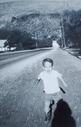 Reed playing in street in front of house, circa 1966-67